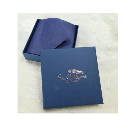 Dark blue jewellery box opened with dark tissue wrapping exposed